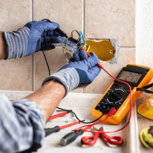 Certified Electrical Services in Johannesburg Certified electrician from 2 Sisters Electrical installing a wall socket in Johannesburg.